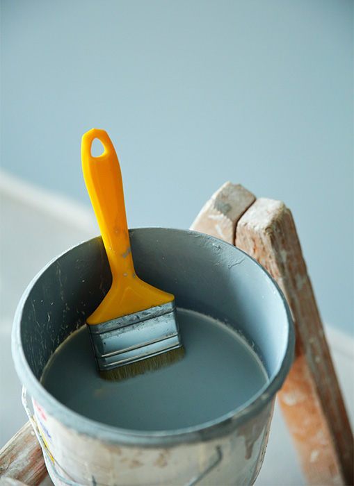 bucket of paint on a ladder